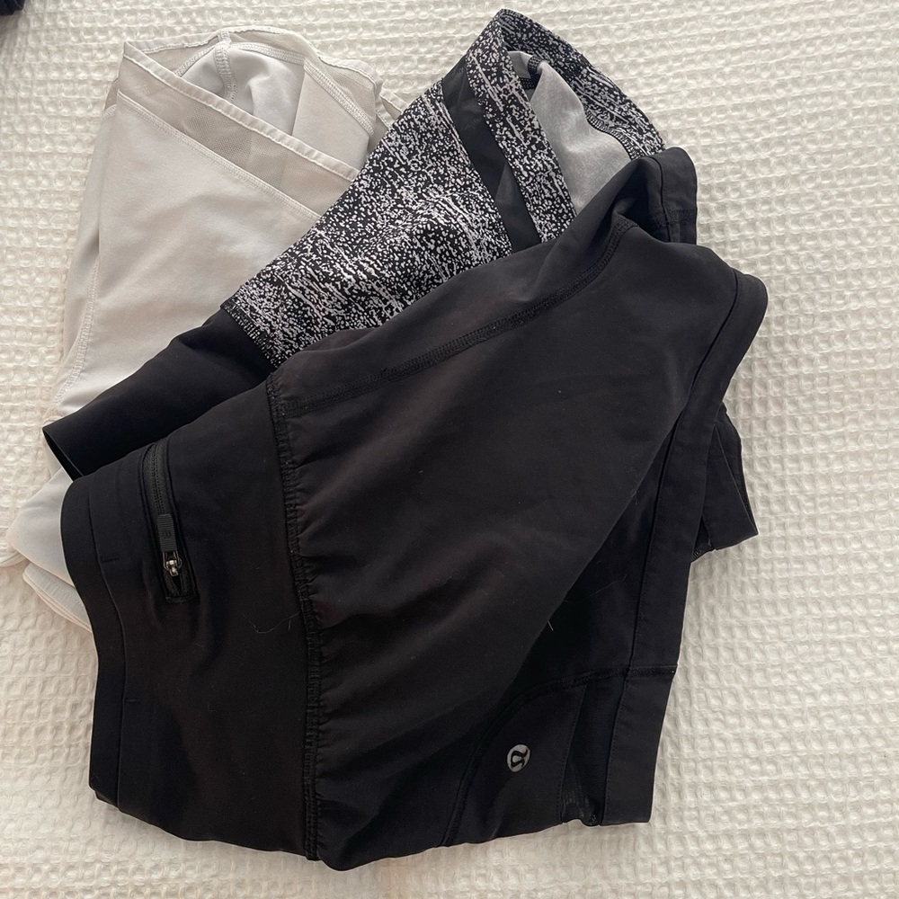 Lot of 3 lululemon shorts - black, pattern, and white.